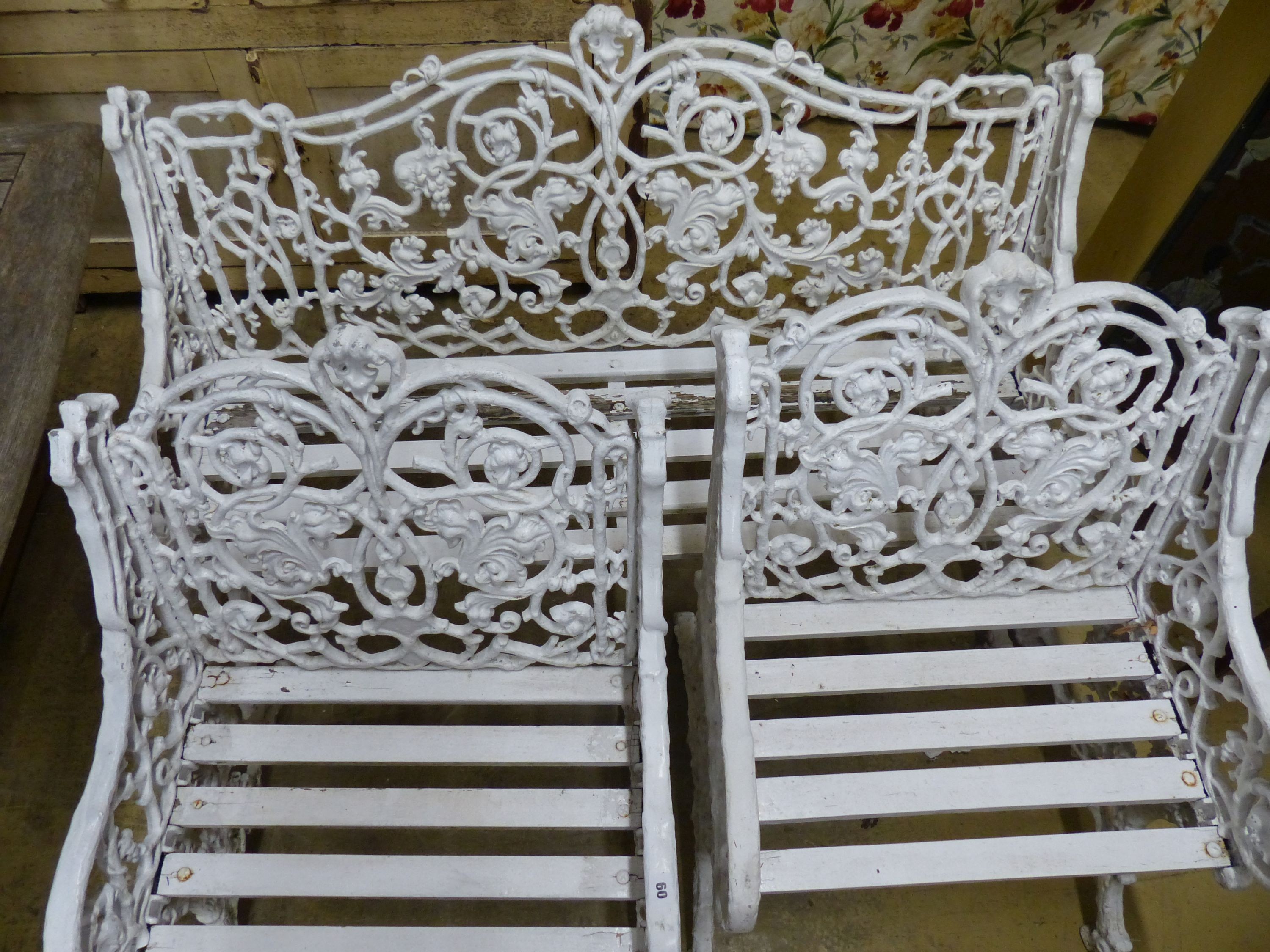 A Victorian style Coalbrookdale design painted metal garden bench and two armchairs, bench W.126cm D.60cm H.90cm